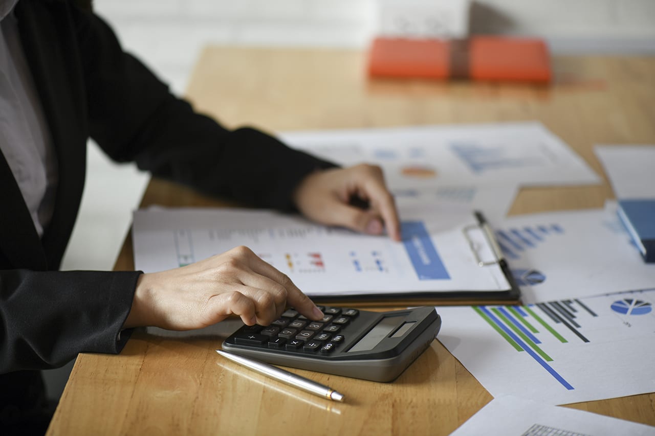 Cropped shot of Accounting staff are using calculators and graph